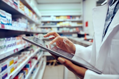 Pharmacist using tablet for inventory