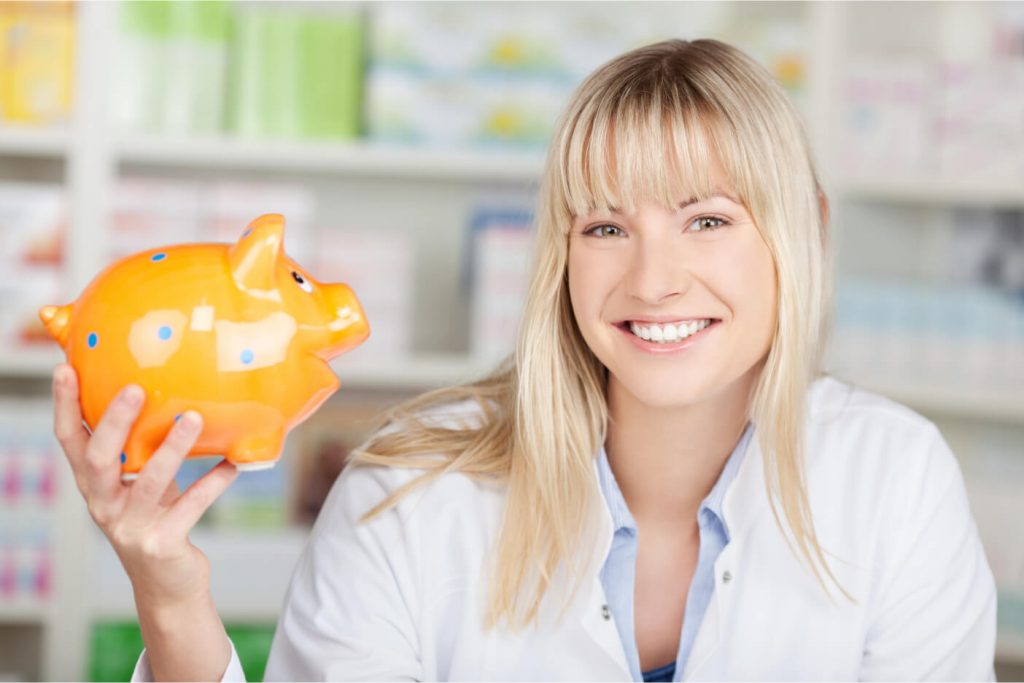 Pharmacist holding piggy bank to show client benefits